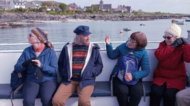 A McKinlay Kidd tour group travelling on a ferry to the Isle of Iona
