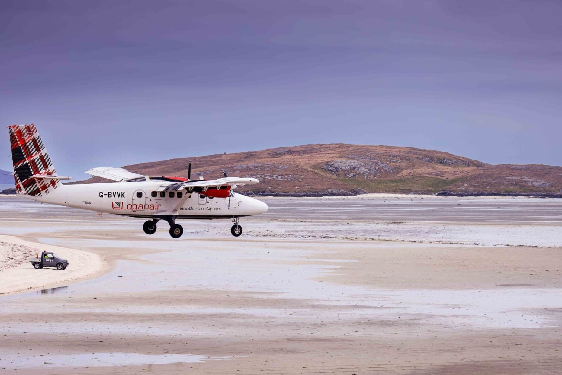 A Loganair flight landing on Barra Airport.