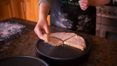A baker making traditional Irish soda bread in a kitchen