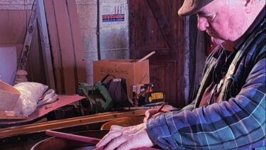 A local carpenter working on creating an Irish bodhran by hand