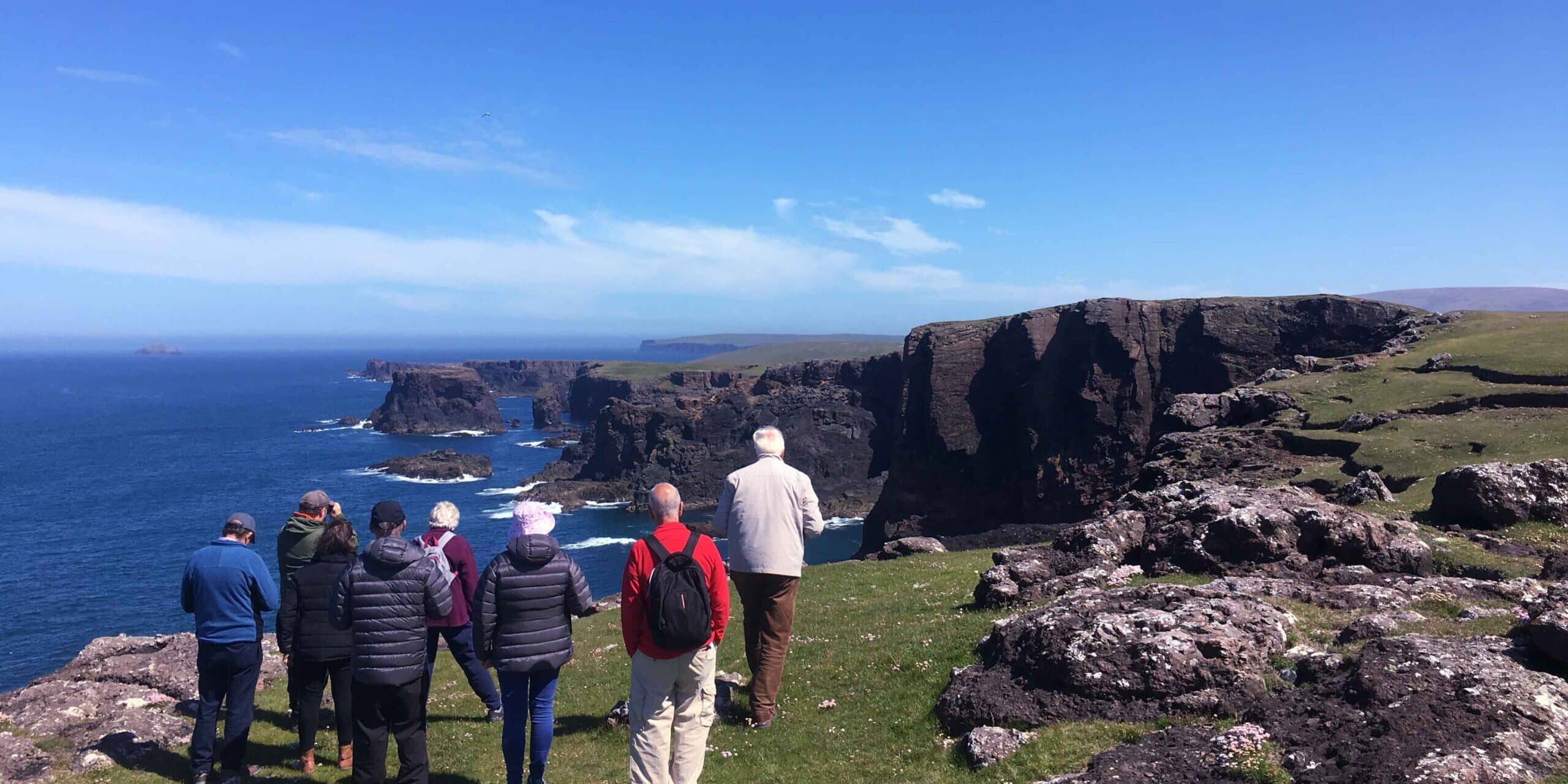 A McKinlay Kidd group visiting the Eshaness Cliffs in Shetland, Scotland