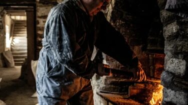 A man milling bere at Barony Mill, Orkney