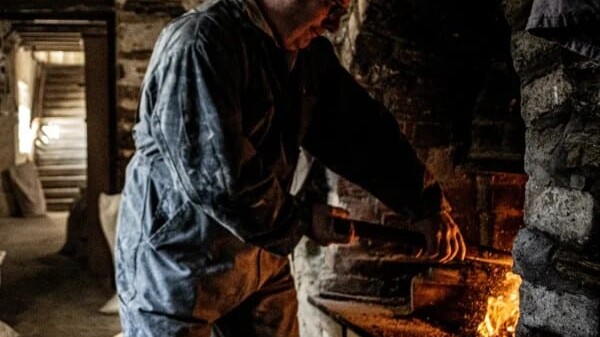 A man milling bere at Barony Mill, Orkney