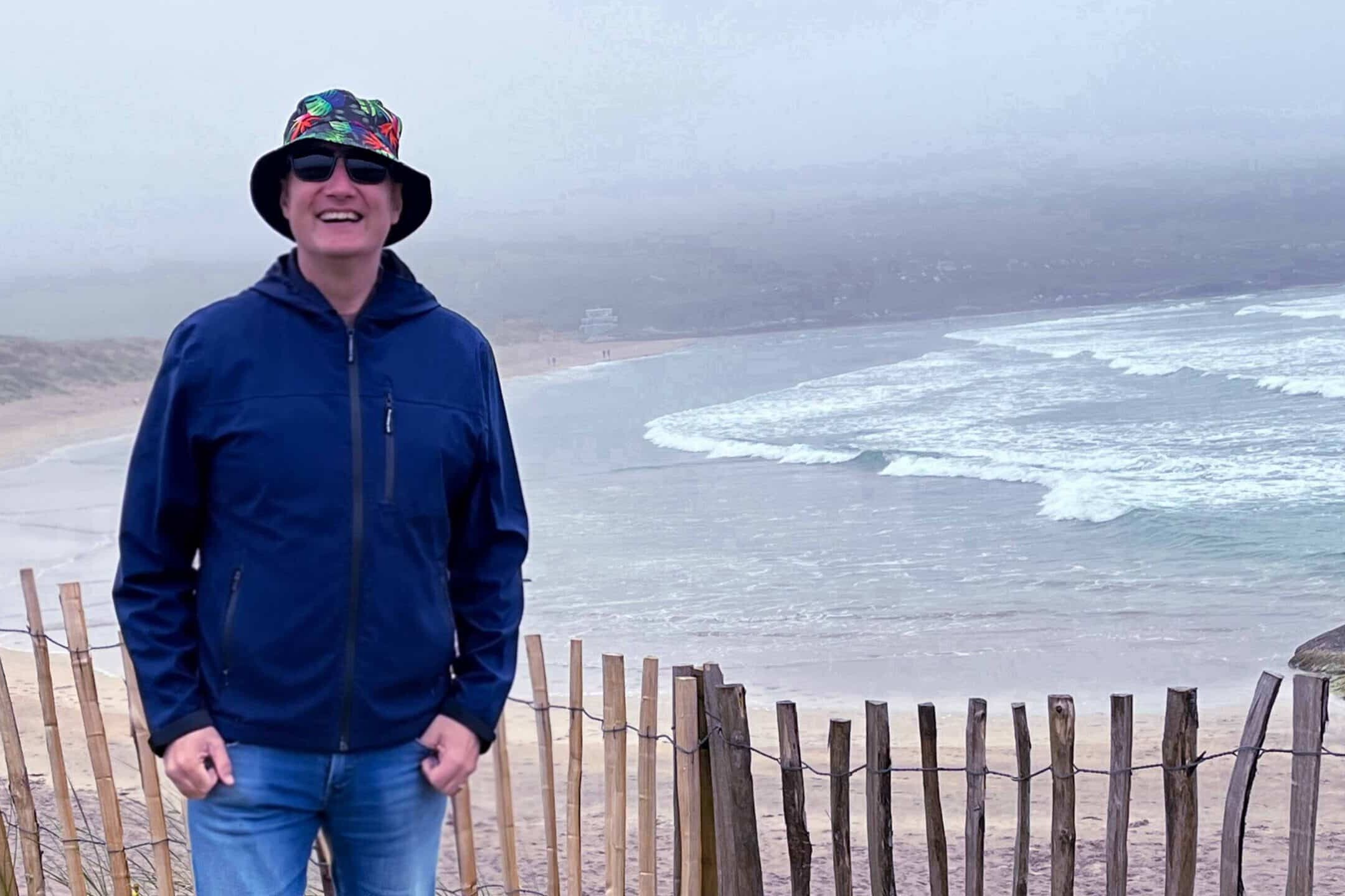 McKinlay Kidd Guide standing in front of a beach in Ireland